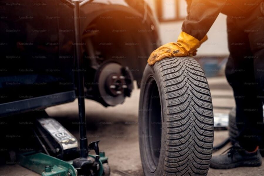 Technician fitting a winter tire