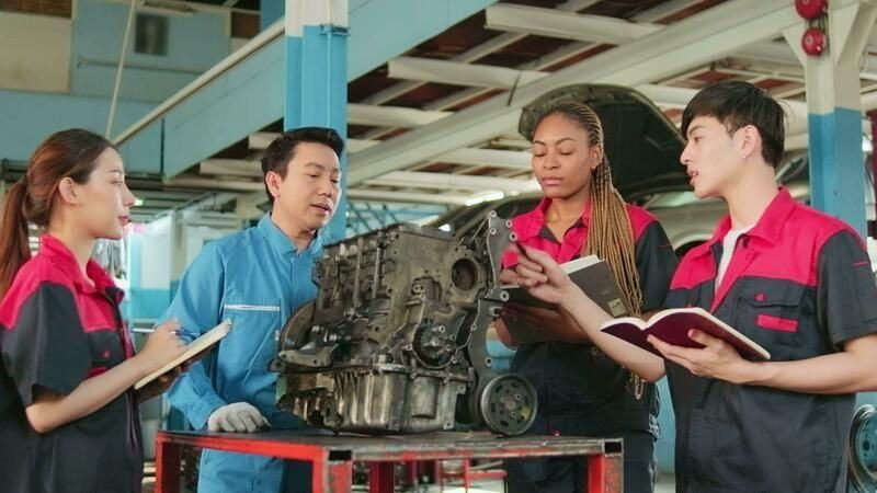 Two technicians reviewing an engine block together