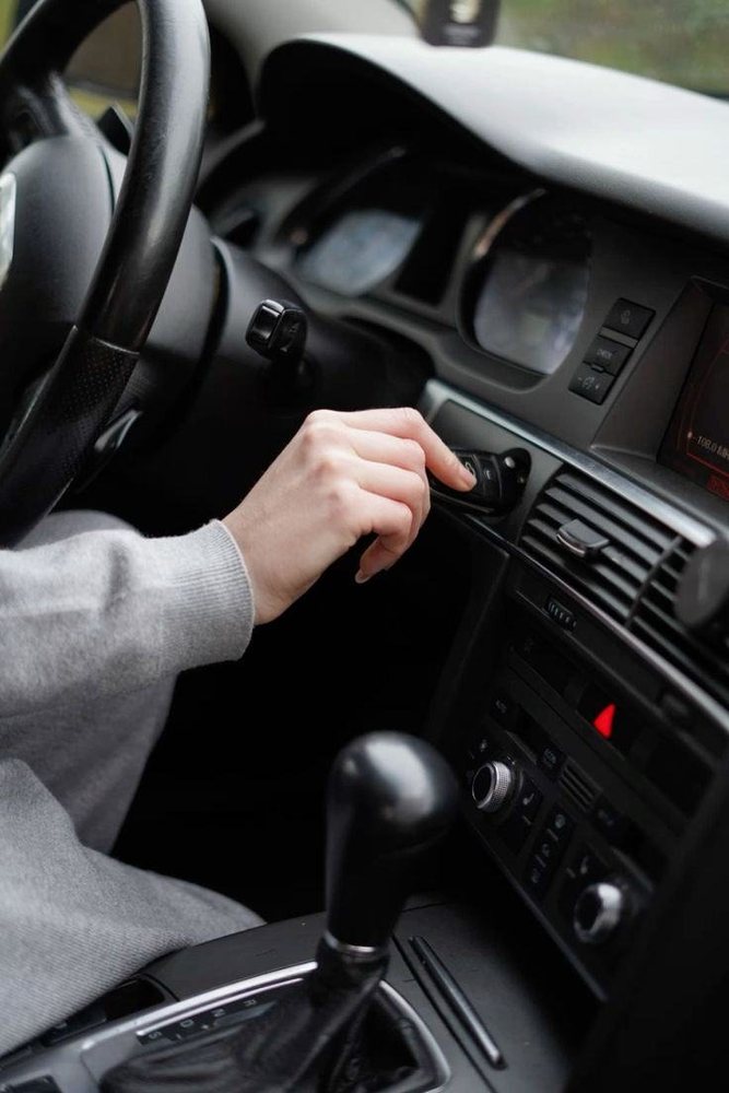 Driver adjusting the air conditioning controls