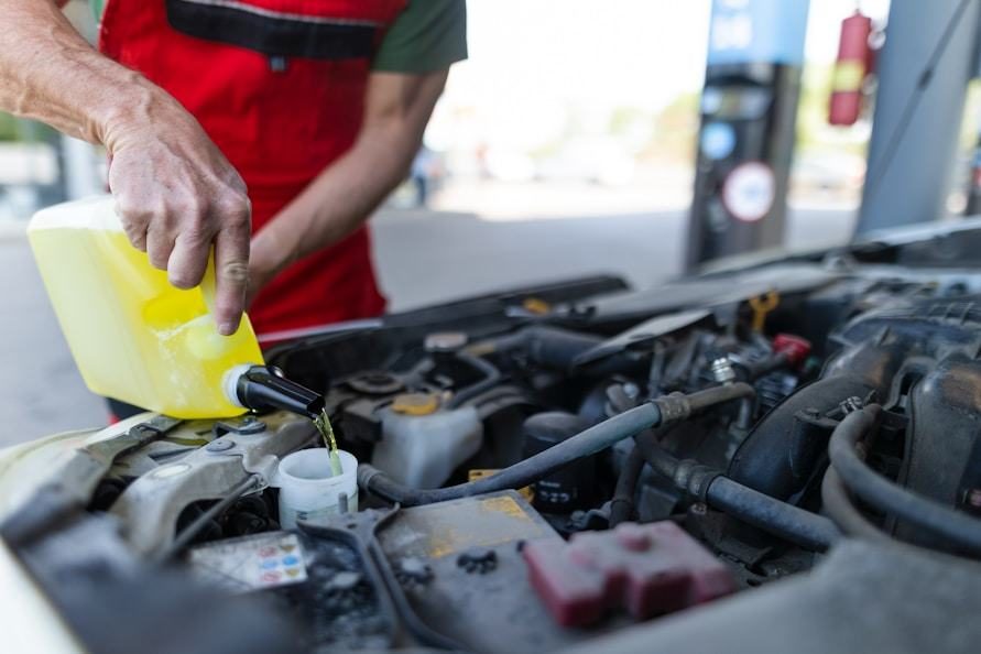 Technician checking fluids under the hood
