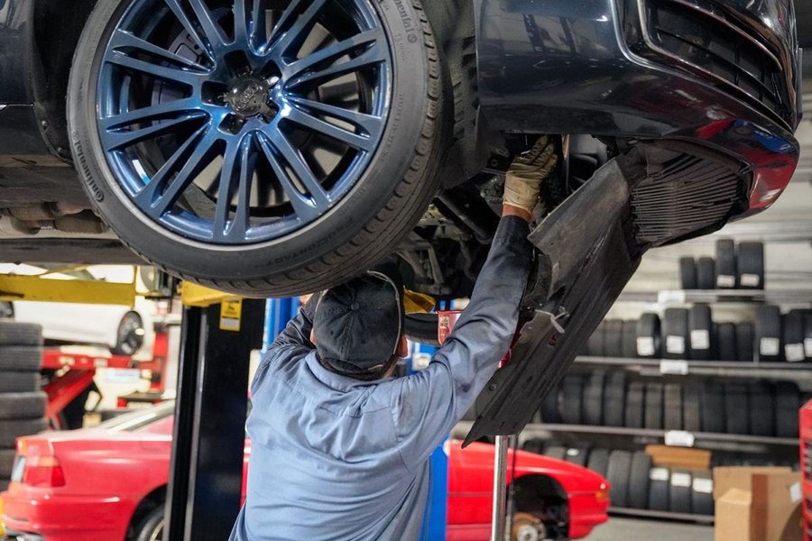 Technician working under a raised car